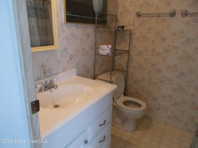 a view of a room that has a table and chairs in it