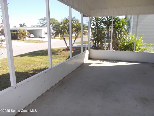 a view of ocean with a floor to ceiling window next to a yard