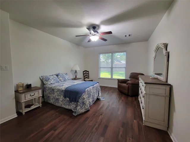 a bedroom with a bed and a couch