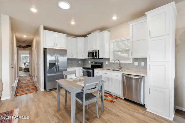 a kitchen with refrigerator cabinets and wooden floor