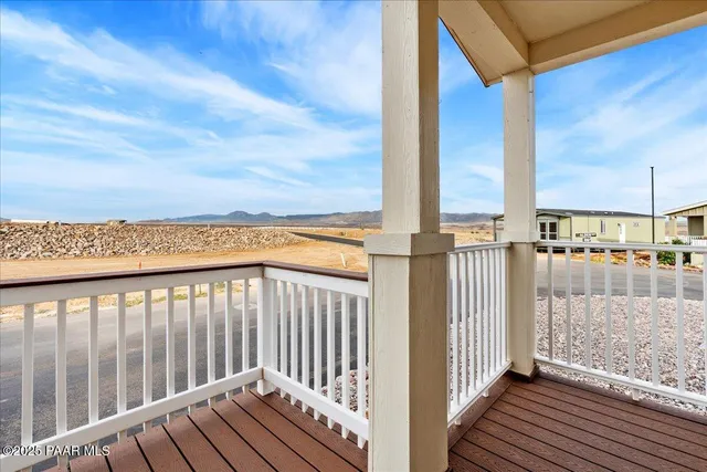 a view of a balcony with wooden floor