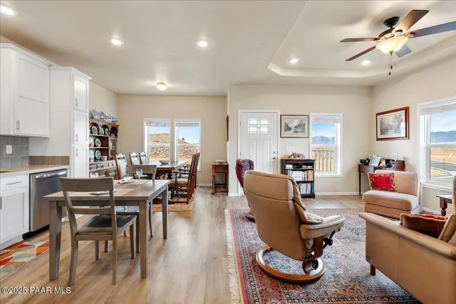a living room with furniture a large window and a table