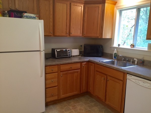 8 Leonard Road Sharon, MA 02067 - Photo 3 of 12 a kitchen with stainless steel appliances granite countertop a refrigerator a sink a stove and white cabinets