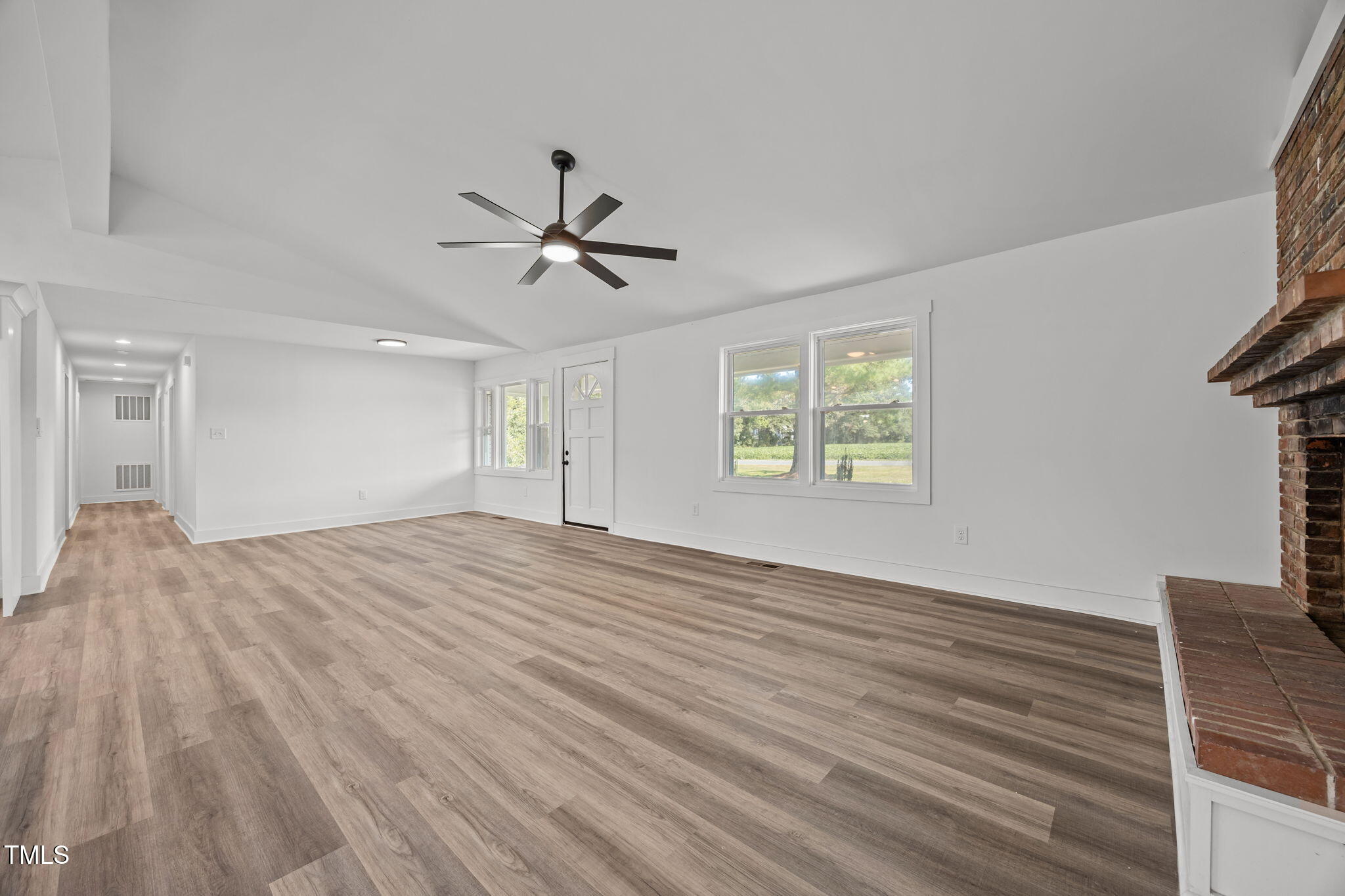 1161 Stewart Road Dunn, NC 28334 - Photo 26 of 50 a view of empty room with wooden floor and fan
