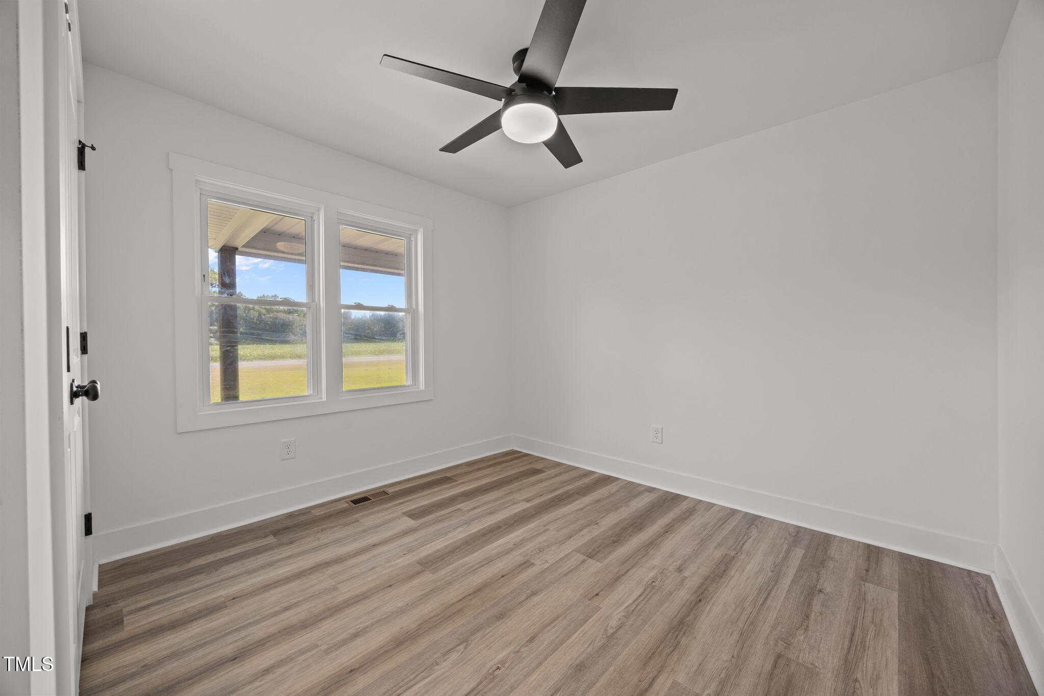 1161 Stewart Road Dunn, NC 28334 - Photo 33 of 50 wooden floor in an empty room with a window