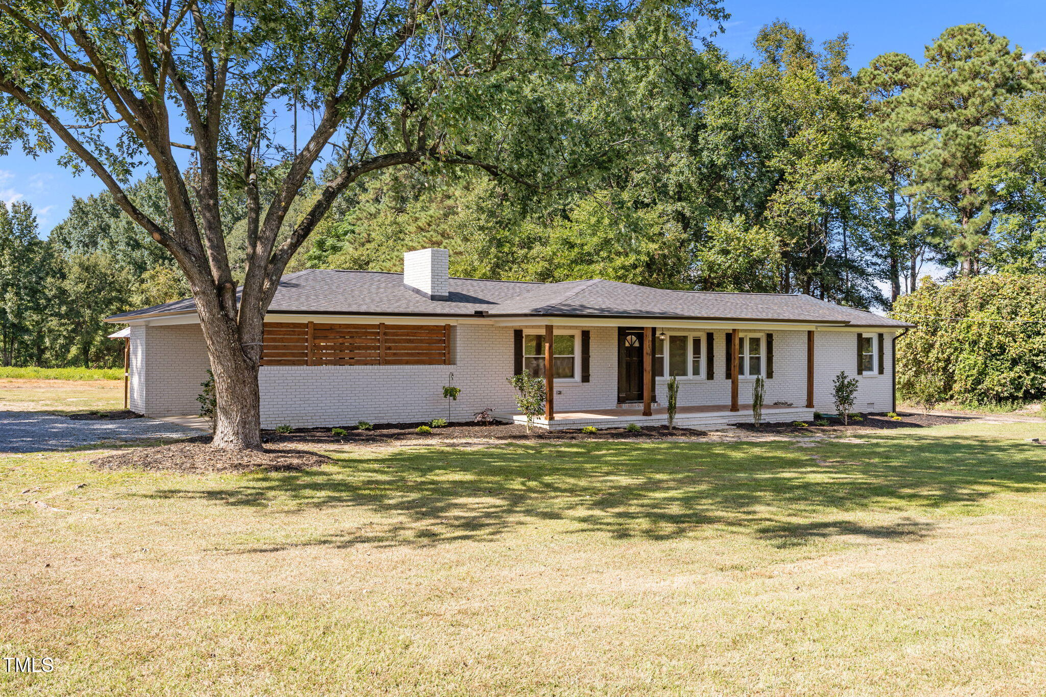 1161 Stewart Road Dunn, NC 28334 - Photo 46 of 50 a view of a house with pool and trees in the background