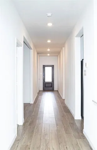 a view of a room with wooden floor and window
