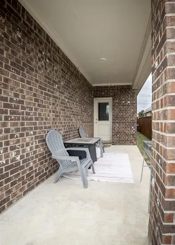 a view of a chairs and table in backyard