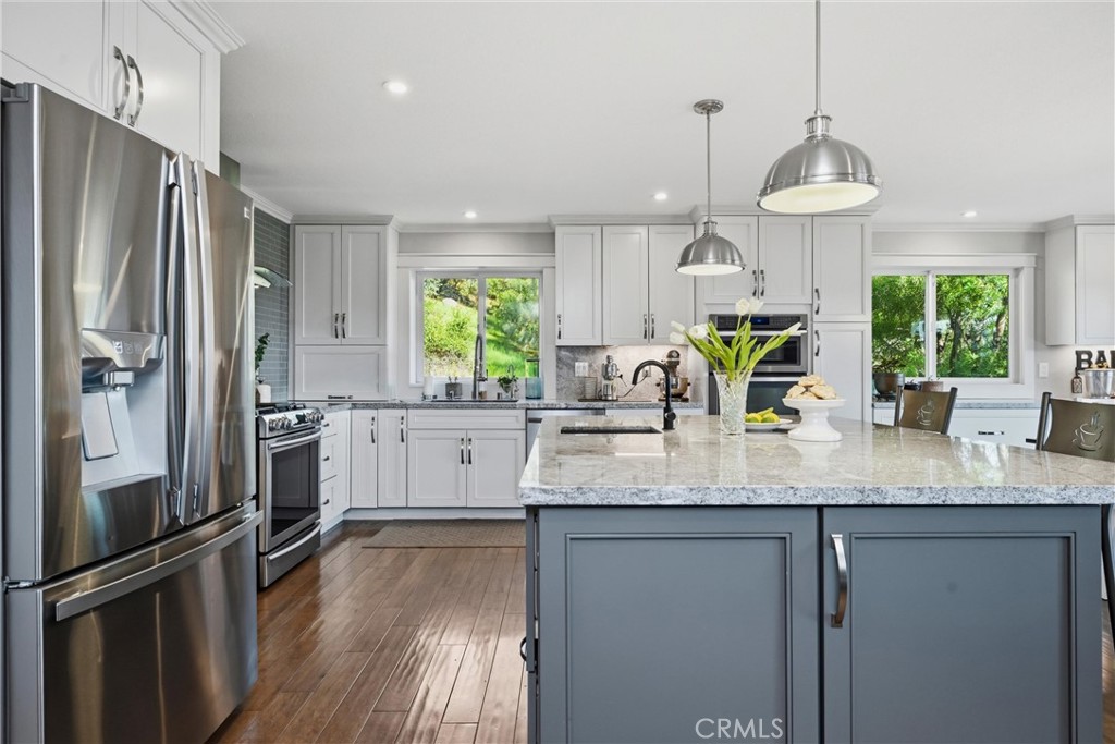 17432 Greenridge Road Hidden Valley Lake, CA 95467 - Photo 22 of 72 a kitchen with stainless steel appliances granite countertop a refrigerator a sink a stove and a wooden floors