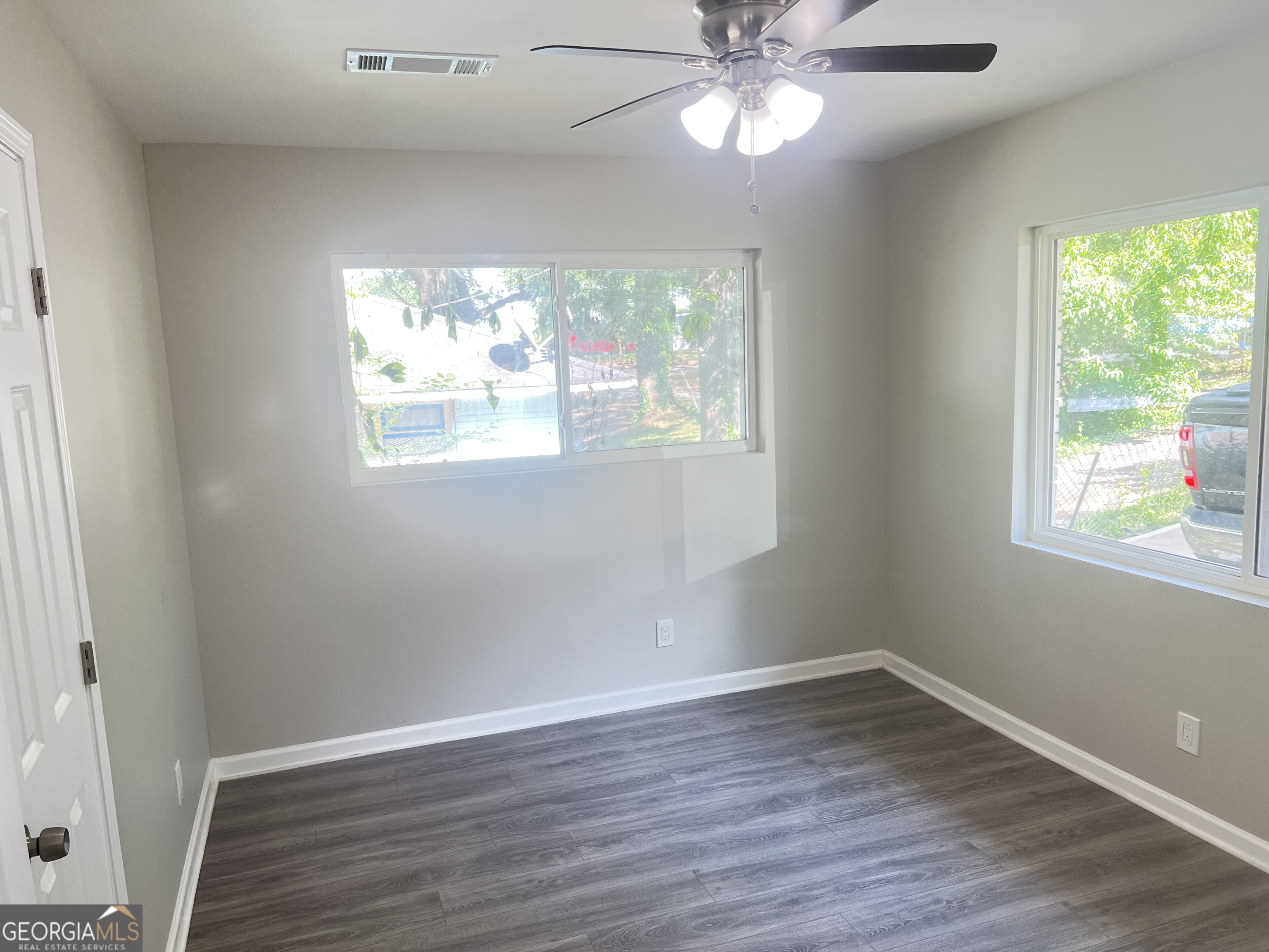 1255 Pine Avenue, Unit 2 East Point, GA 30344 - Photo 8 of 12 wooden floor in an empty room with a window