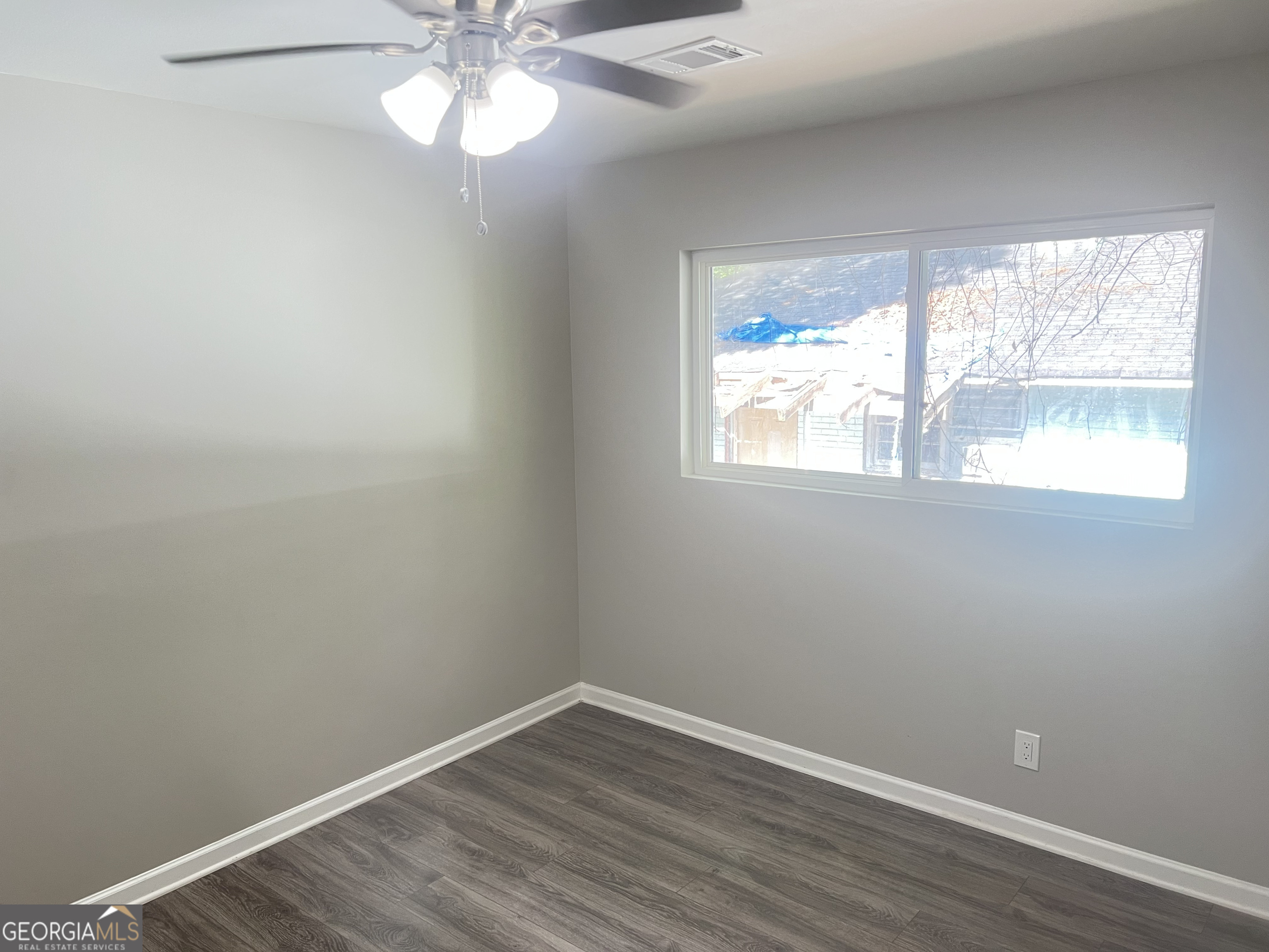 1255 Pine Avenue, Unit 2 East Point, GA 30344 - Photo 10 of 12 an empty room with wooden floor and windows