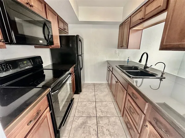 a kitchen with a sink and stainless steel appliances