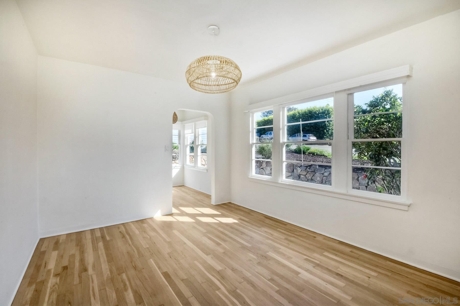 855 Dewitt Avenue Encinitas, CA 92024 - Photo 13 of 23 an empty room with wooden floor and windows