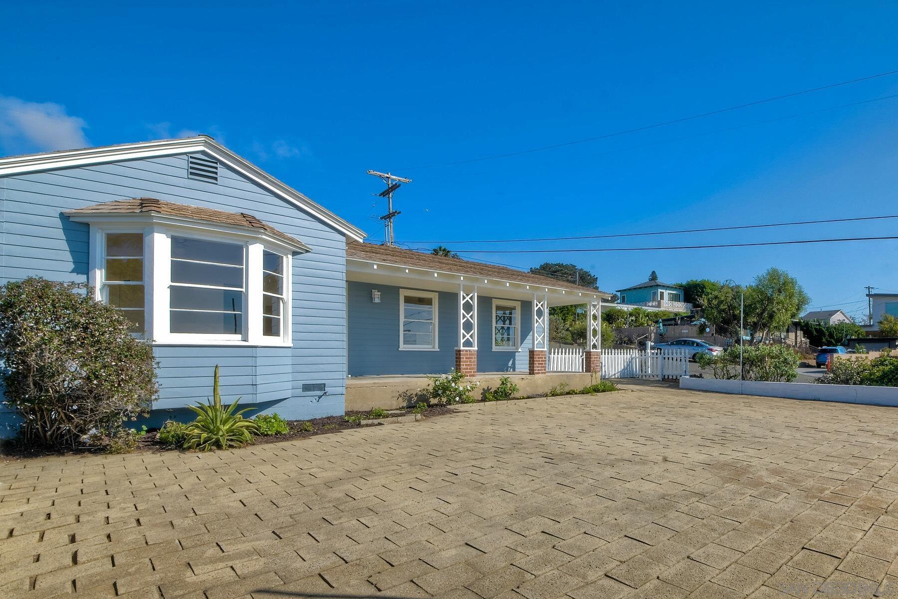 855 Dewitt Avenue Encinitas, CA 92024 - Photo 2 of 23 a front view of a house with a yard and potted plants