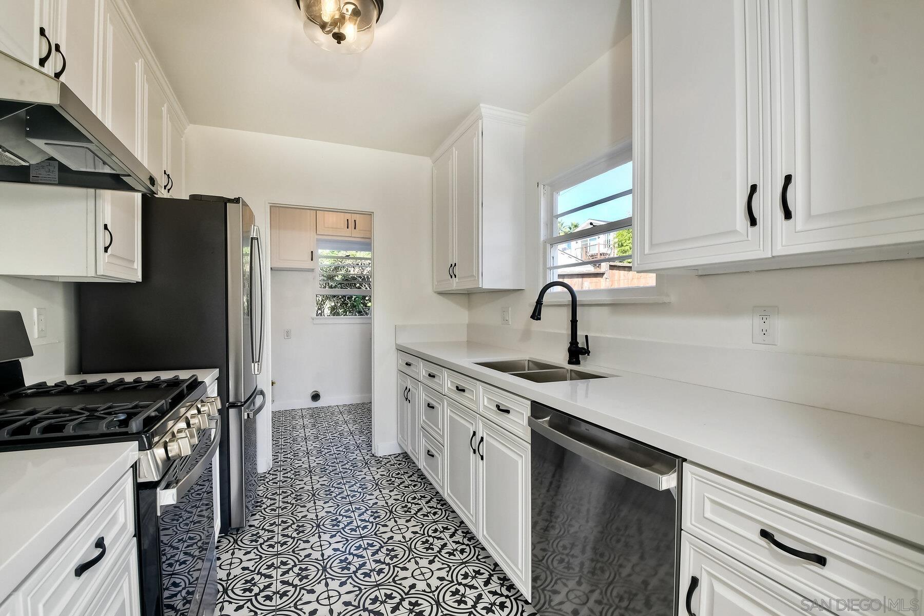 855 Dewitt Avenue Encinitas, CA 92024 - Photo 8 of 23 a kitchen with a sink stove and refrigerator