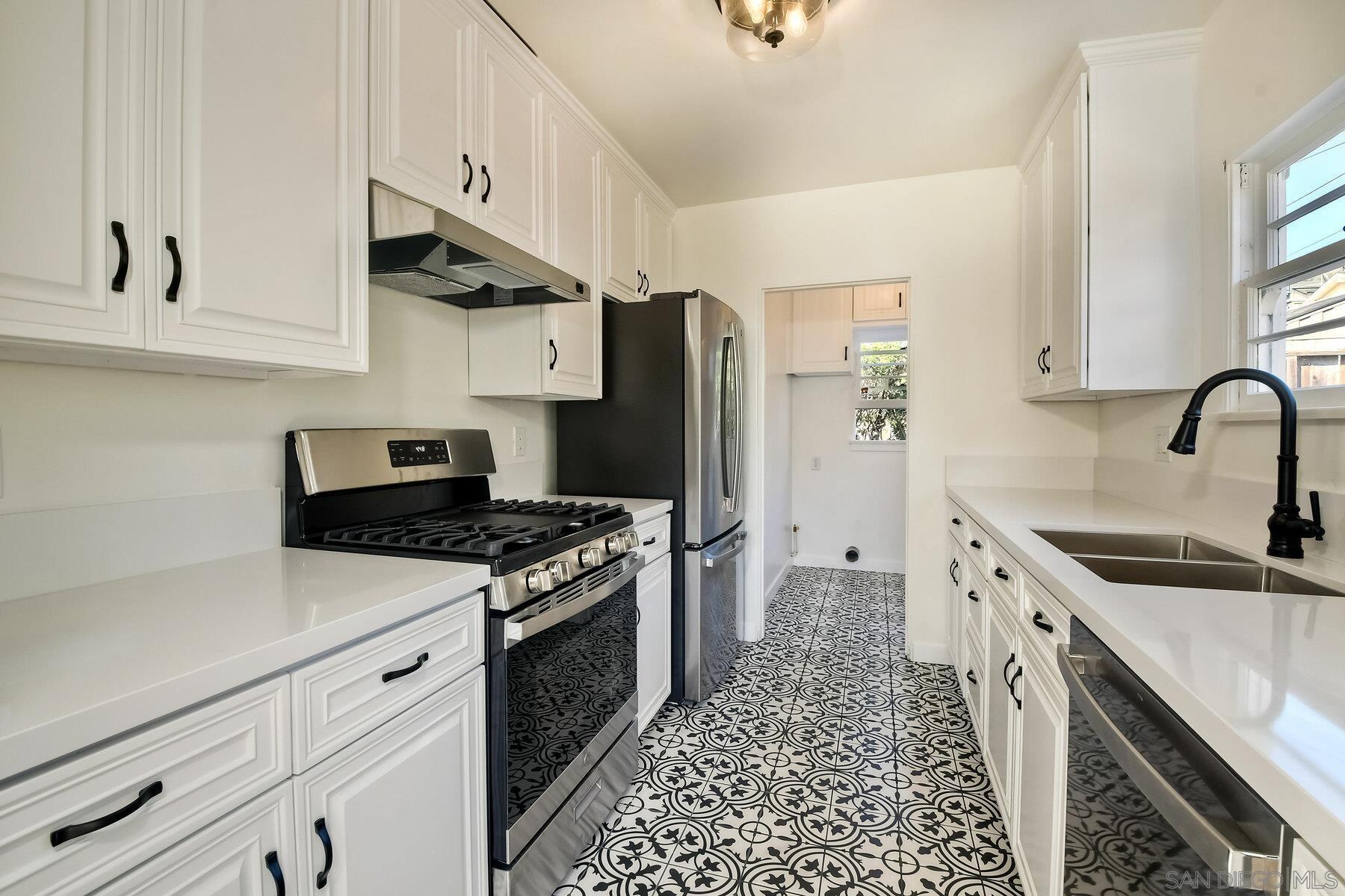 855 Dewitt Avenue Encinitas, CA 92024 - Photo 9 of 23 a kitchen with stainless steel appliances granite countertop a stove and a sink
