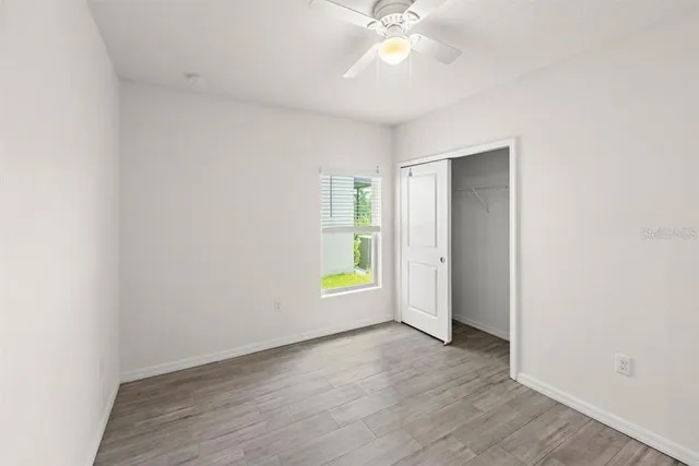 an empty room with wooden floor and entryway