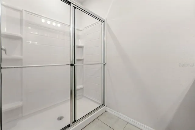 a bathroom with a glass shower door