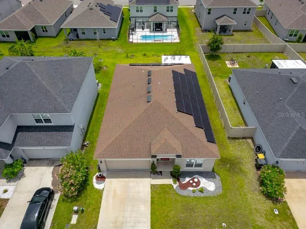 an aerial view of a house with a swimming pool