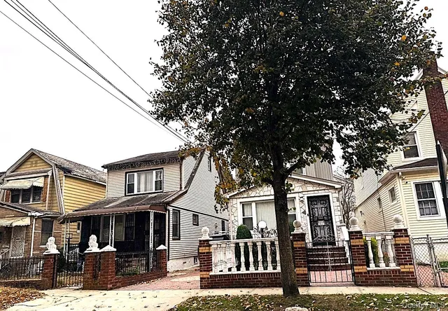 a front view of a residential apartment building with a yard