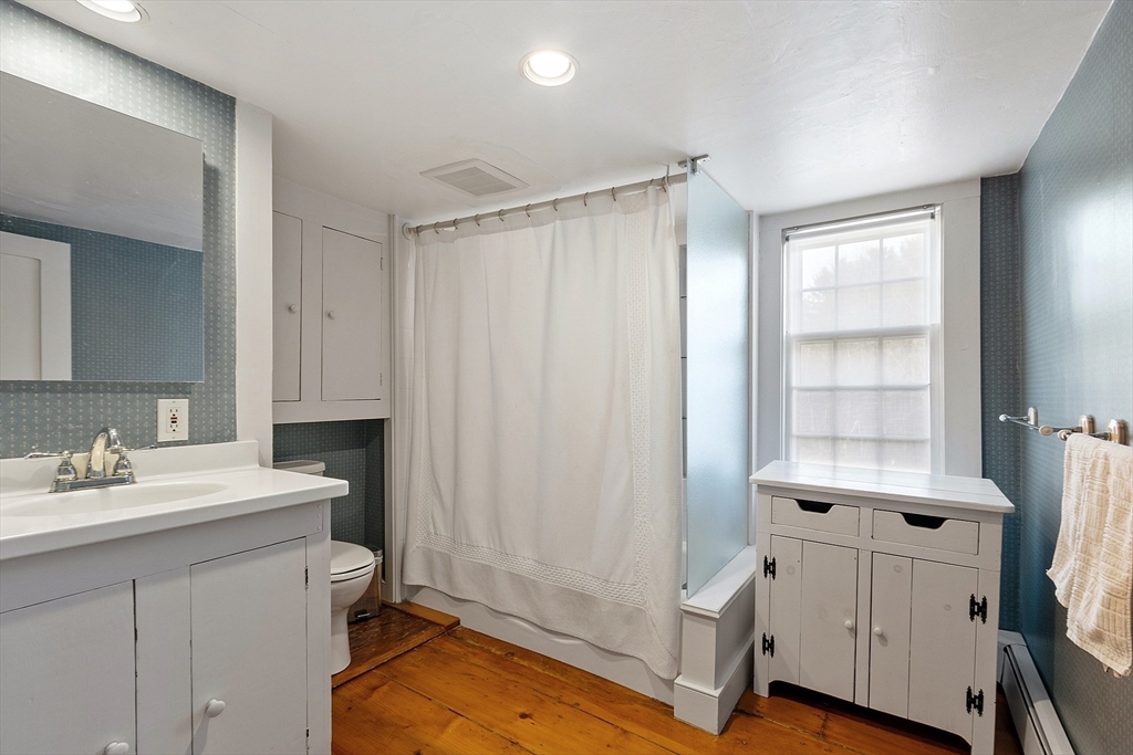 1019 North Road Carlisle, MA 01741 - Photo 21 of 31 a bathroom with a sink a toilet and shower