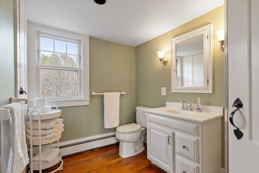 1019 North Road Carlisle, MA 01741 - Photo 23 of 31 a bathroom with a toilet sink and mirror