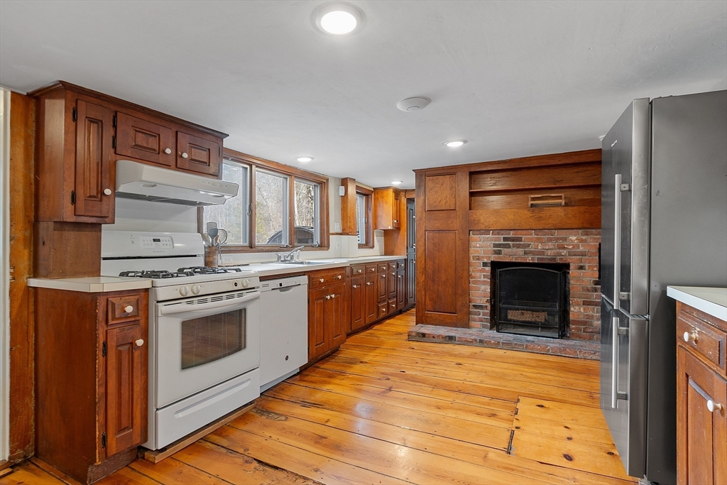 1019 North Road Carlisle, MA 01741 - Photo 7 of 31 a kitchen with stainless steel appliances granite countertop a stove top oven and cabinets