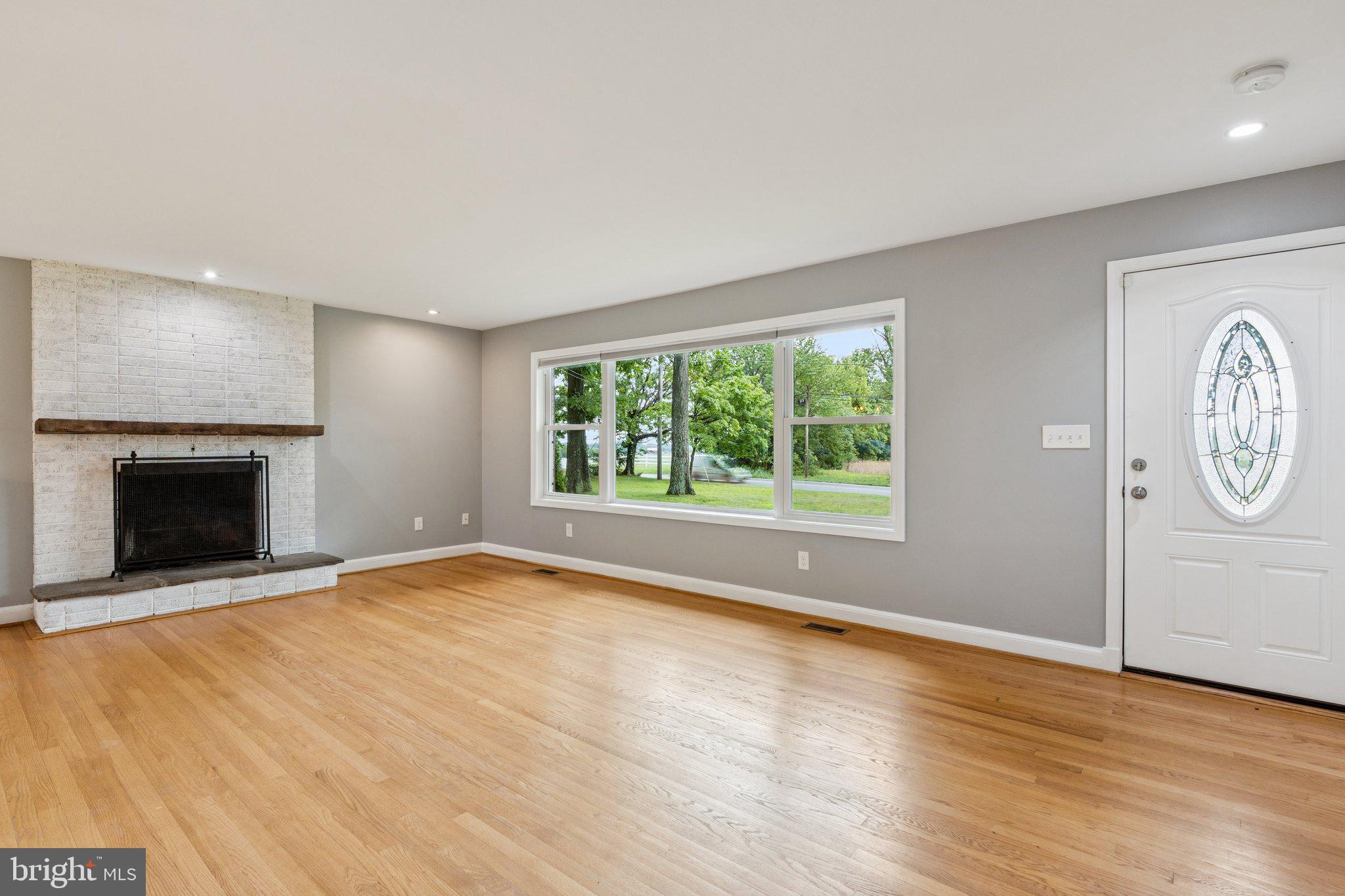 12645 Fingerboard Road Monrovia, MD 21770 - Photo 5 of 47 an empty room with windows and fireplace