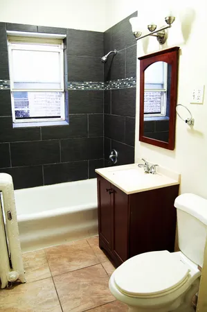 a bathroom with a sink a toilet and bathtub