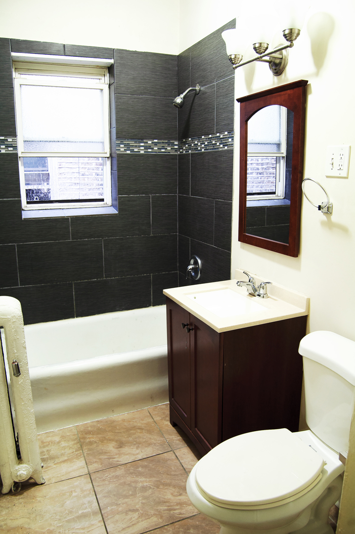 4823 North Springfield Avenue, Unit 2E Chicago, IL 60625 - Photo 3 of 6 a bathroom with a sink a toilet and bathtub