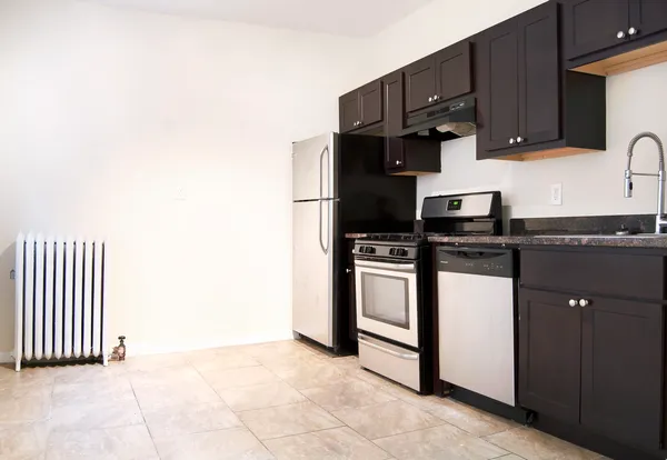 a kitchen with granite countertop a stove a sink and a microwave