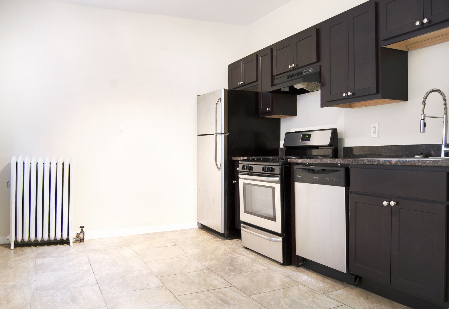 4823 North Springfield Avenue, Unit 2E Chicago, IL 60625 - Photo 5 of 6 a kitchen with granite countertop a stove a sink and a microwave