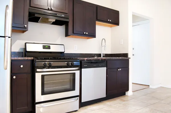 a kitchen with stainless steel appliances granite countertop a stove and a microwave