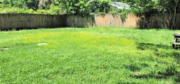 a backyard of a house with lots of green space