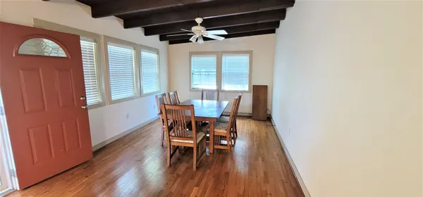 a dining room with furniture and wooden floor