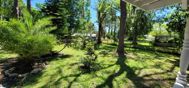 a backyard of a house with lots of green space