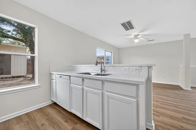 a kitchen with white cabinets and white appliances