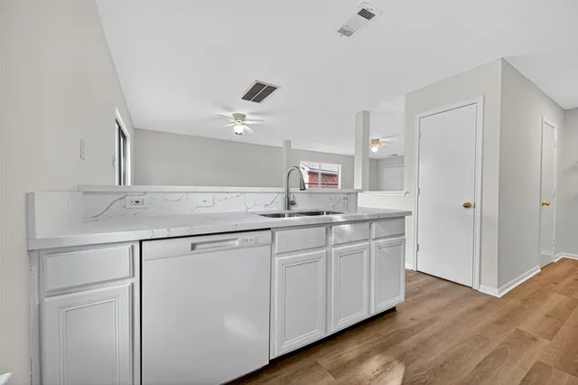 a kitchen with a sink and refrigerator