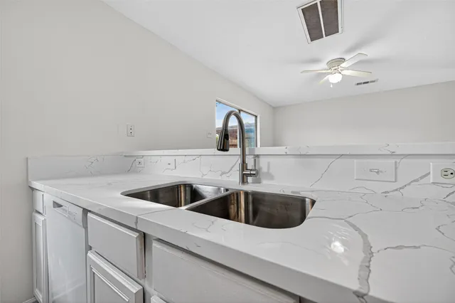 a view of a kitchen with wooden floor and electronic appliances