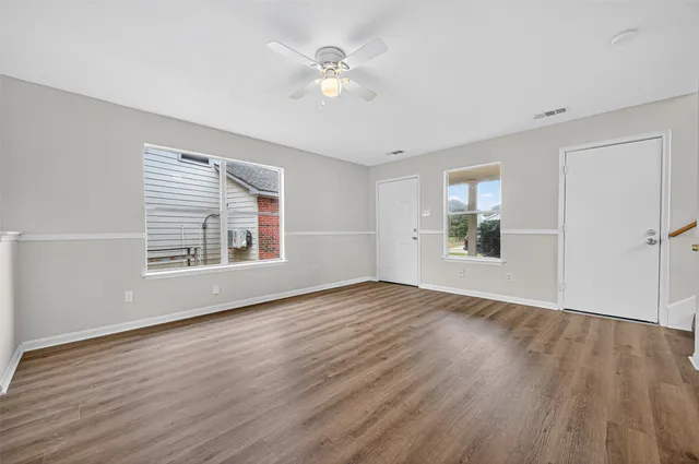 wooden floor in an empty room with a window