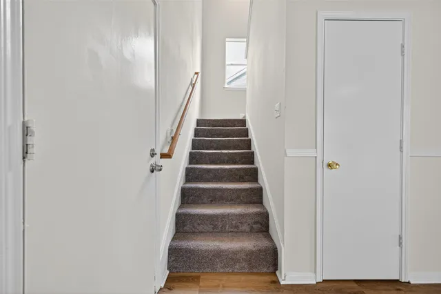 an empty room with a ceiling fan and a window