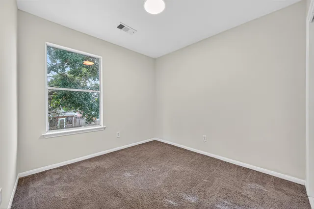 a view of an empty room and entryway