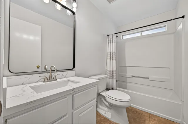 a bathroom with a shower and a toilet