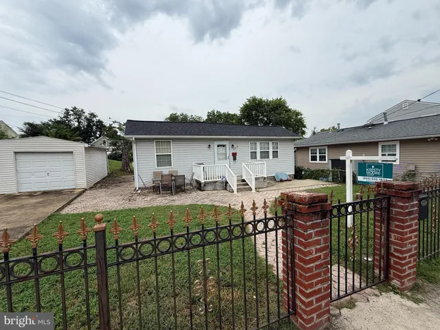 a view of a patio with table and chairs with wooden fence