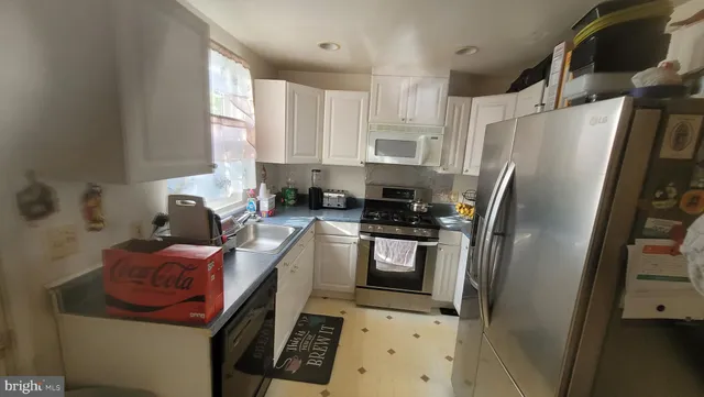 a kitchen with stainless steel appliances a refrigerator sink and stove