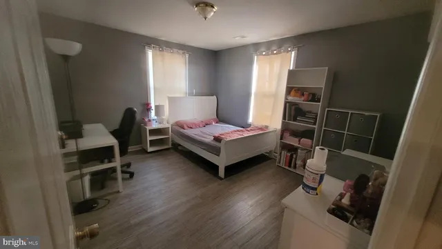 a bedroom with furniture and a wooden floor