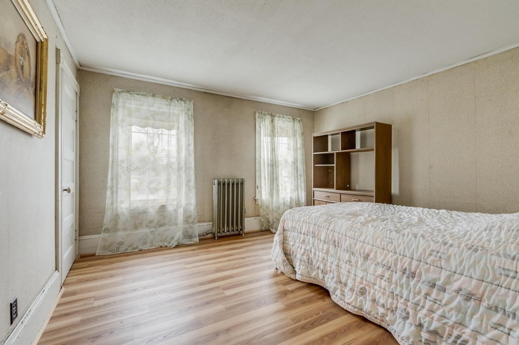 9 Trowbridge Circuit Worcester, MA 01603 - Photo 20 of 40 a bedroom with a bed and wooden floor