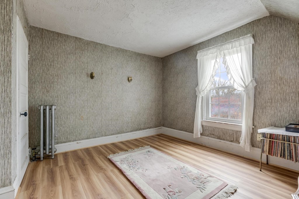 9 Trowbridge Circuit Worcester, MA 01603 - Photo 21 of 40 an empty room with wooden floor and windows