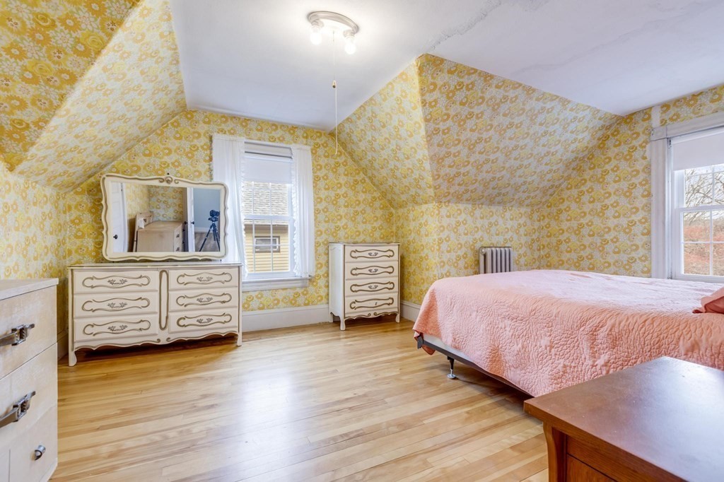 9 Trowbridge Circuit Worcester, MA 01603 - Photo 23 of 40 a bedroom with a bed and wooden floor