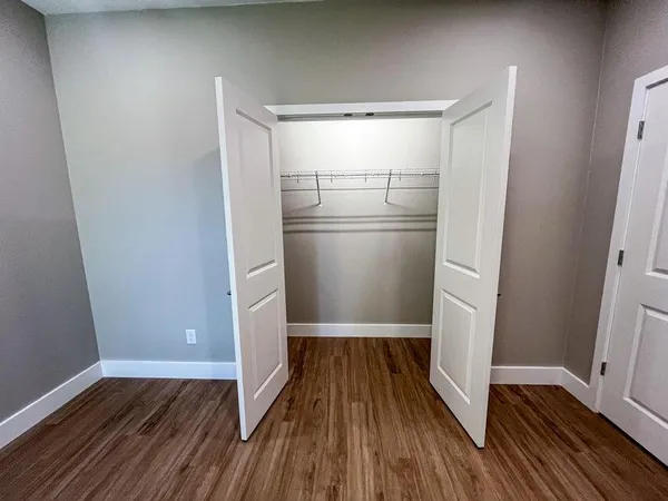 a view of a room with wooden floor